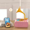 A pink toy gramophone is shown on a table next to a smartphone displaying a book cover. A Bluetooth symbol is depicted connecting the two devices. Produktbild-Vorschau