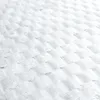 A close-up, angled view of a white quilted blanket. Náhled obrázku produktu