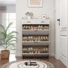 A shoe cabinet with multiple shelves and drawers is shown in a hallway next to a door and a large potted plant. Náhľad obrázku produktu
