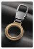 A close-up shot of a golden keychain accessory for an Apple AirTag, resting on a textured black surface. Produktbild-Vorschau