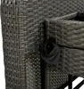 A close-up view of the woven rattan material of outdoor furniture, showing a black accessory attached to the side. Podgląd zdjęcia produktu