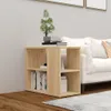A wooden side table with books and a plant next to a white sofa. Podgląd zdjęcia produktu
