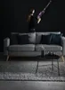 A woman is holding a vacuum cleaner in a living room setting. Voir les images du produit