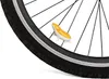 A close-up shot of a bicycle wheel with a small, yellow and white hamster-shaped accessory attached to the spokes. Podgląd zdjęcia produktu
