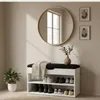 A shoe cabinet with a seat in a hallway, decorated with a plant and artwork. Produktbild-Vorschau