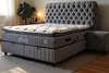 A bedroom scene with a bed and nightstand. Produktbild-Vorschau