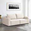 A beige modular sofa is shown in a room with a painting on the wall and a window in the background. Voir les images du produit