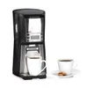 A coffee maker with a cup of coffee and cookies. Produktbild-Vorschau
