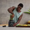 A man is making a smoothie in a kitchen. Produktbild-Vorschau