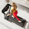 A woman is running on a treadmill in a home gym setting. Produktbild-Vorschau