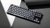A keyboard is placed on a surface with dramatic lighting and shadows. Produktbild-Vorschau