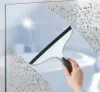 A hand is using a squeegee to clean a glass surface with water droplets. Produktbild-Vorschau