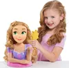 A young girl is styling a Rapunzel doll's hair. Náhľad obrázku produktu