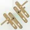 A set of four door handles with their mounting plates, arranged diagonally on a light-colored background. Produktbild-Vorschau