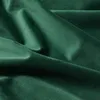 A close-up view of dark green velvet fabric, showing its texture and folds. Produktbild-Vorschau