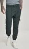 A person wearing black cargo jogging pants and white sneakers, standing against a white background. Anteprima dell’immagine prodotto