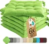 A stack of six green seat cushions with a tag attached. Voir les images du produit