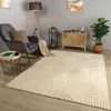 A cozy living room scene with a rug, armchair, floor lamp, and side table. Produktbild-Vorschau