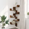 A corner shelf unit with various decorative items and books, placed in a room with a large plant and curtains. Náhled obrázku produktu