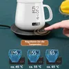 A hand is shown pressing a button on a mug warmer, with three digital displays showing different temperature settings below. Produktbild-Vorschau