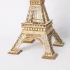 A close-up, studio shot of a wooden model of the Eiffel Tower against a white background. Produktbild-Vorschau