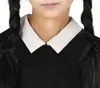 Close-up of a person wearing a black dress with a white collar and black braided pigtails. Produktbild-Vorschau