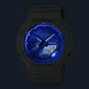 A close-up shot of a G-Shock watch with a blue illuminated dial. Voir les images du produit