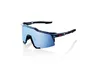 A pair of black and blue sports sunglasses with blue mirrored lenses, shown from a side angle on a white background. Náhled obrázku produktu