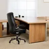An office chair in front of a large desk. Produktbild-Vorschau