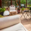 A sunroom or conservatory setting with furniture and plants. Produktbild-Vorschau