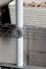 Close-up of a gray adjustment knob on a white pole, with a wire basket visible in the background. Produktbild-Vorschau