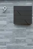A modern mailbox mounted on a textured gray brick wall, with the number '9' to its left. Náhled obrázku produktu