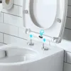 Close-up of a toilet seat being installed, showing the hinge mechanism and mounting posts. Náhled obrázku produktu