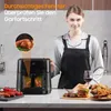 A woman in an apron stands in a kitchen next to an air fryer, with food displayed on the counter. Produktbild-Vorschau