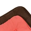 A close-up view of a corner of a sleeping bag or mat, showing the brown trim and the coral-colored interior. Produktbild-Vorschau