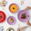 A table setting with multiple plates of food and cutlery, suggesting a meal. Produktbild-Vorschau