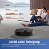 A woman is reading a book on the floor next to a couch, while a robot vacuum cleaner operates in the foreground. A graphic overlay displays noise level comparisons. Produktbild-Vorschau