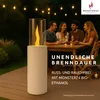 People gathered around a table on a deck at night, with a bioethanol fireplace in the foreground. Produktbild-Vorschau