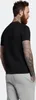 A man wearing a black t-shirt and light grey sweatpants, viewed from the back. Produktbild-Vorschau