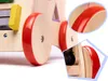 Close-up view of a wooden toy walker with red wheels and colorful geometric shapes. Náhled obrázku produktu