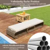 A lounge chair and small table on a wooden deck next to a pool, with grass in the background. Náhled obrázku produktu