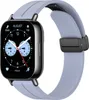 A smartwatch with a light blue strap and a black magnetic clasp is shown against a white background.