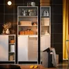 A bathroom storage unit with shelves and cabinets, featuring towels, baskets, and bottles, next to a laundry hamper. Náhled obrázku produktu