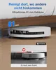 A robot vacuum cleaner is shown cleaning under a bed, highlighting its slim design. Produktbild-Vorschau