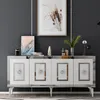 A white sideboard with silver accents is displayed against a dark gray wall, adorned with decorative items and artwork. Anteprima dell’immagine prodotto