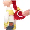 A close-up of a doll's back, showing a string being pulled through a loop on its shirt, attached to its braided hair. Podgląd zdjęcia produktu