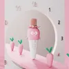 A whimsical scene with a pink karaoke microphone resembling a character, surrounded by carrot-shaped decorations, set against a clock-like backdrop. Produktbild-Vorschau