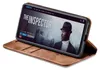 A smartphone in a brown flip case is displayed on a white background, showing a movie streaming interface on its screen. Produktbild-Vorschau