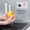 A person is washing a yellow bell pepper under a modern kitchen faucet. Anteprima dell’immagine prodotto