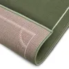 A close-up view of a green rug, showing the underside and a corner detail. Anteprima dell’immagine prodotto